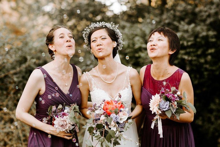 Bridal party blowing bubbles