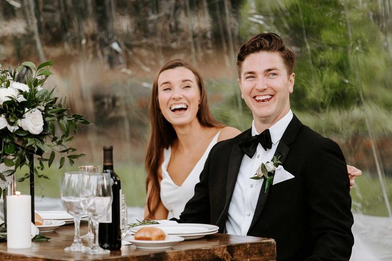 Bride and groom laughing at toasts